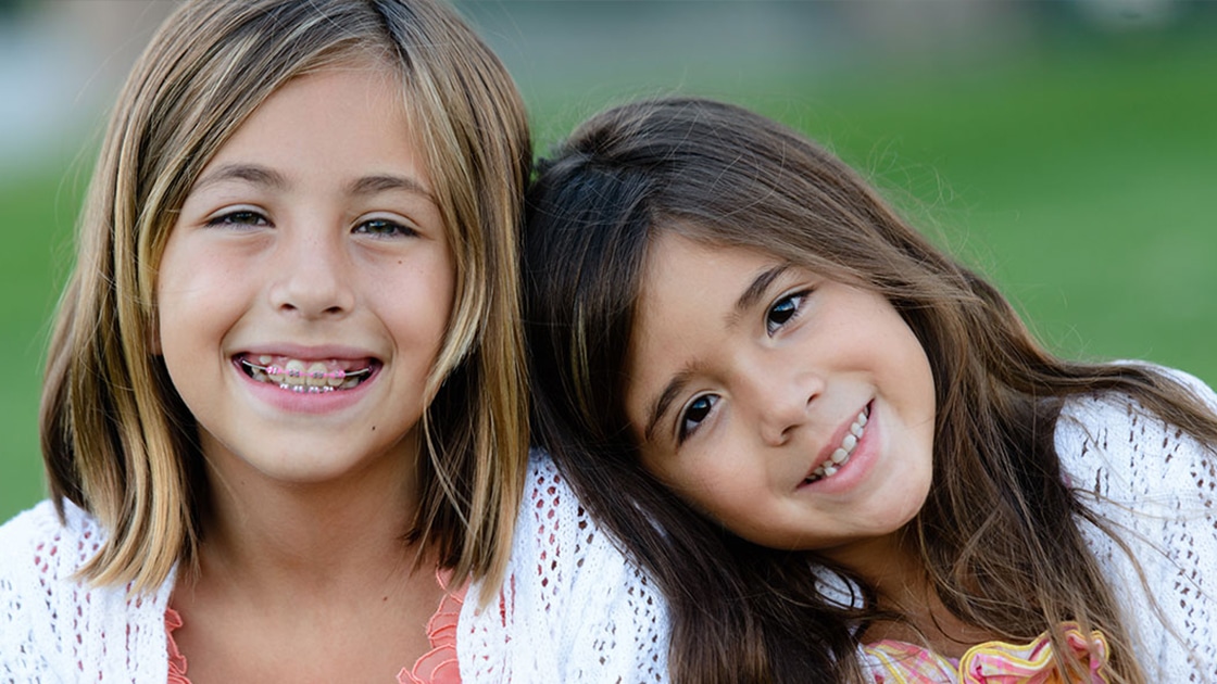 Young girls smiling outdoors